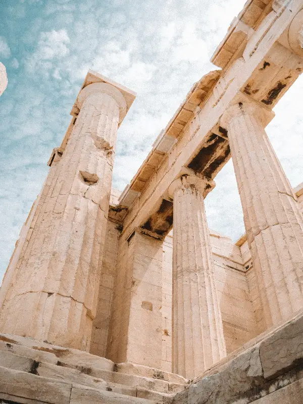 Ruins of ancient classical stone columns under a bright sky